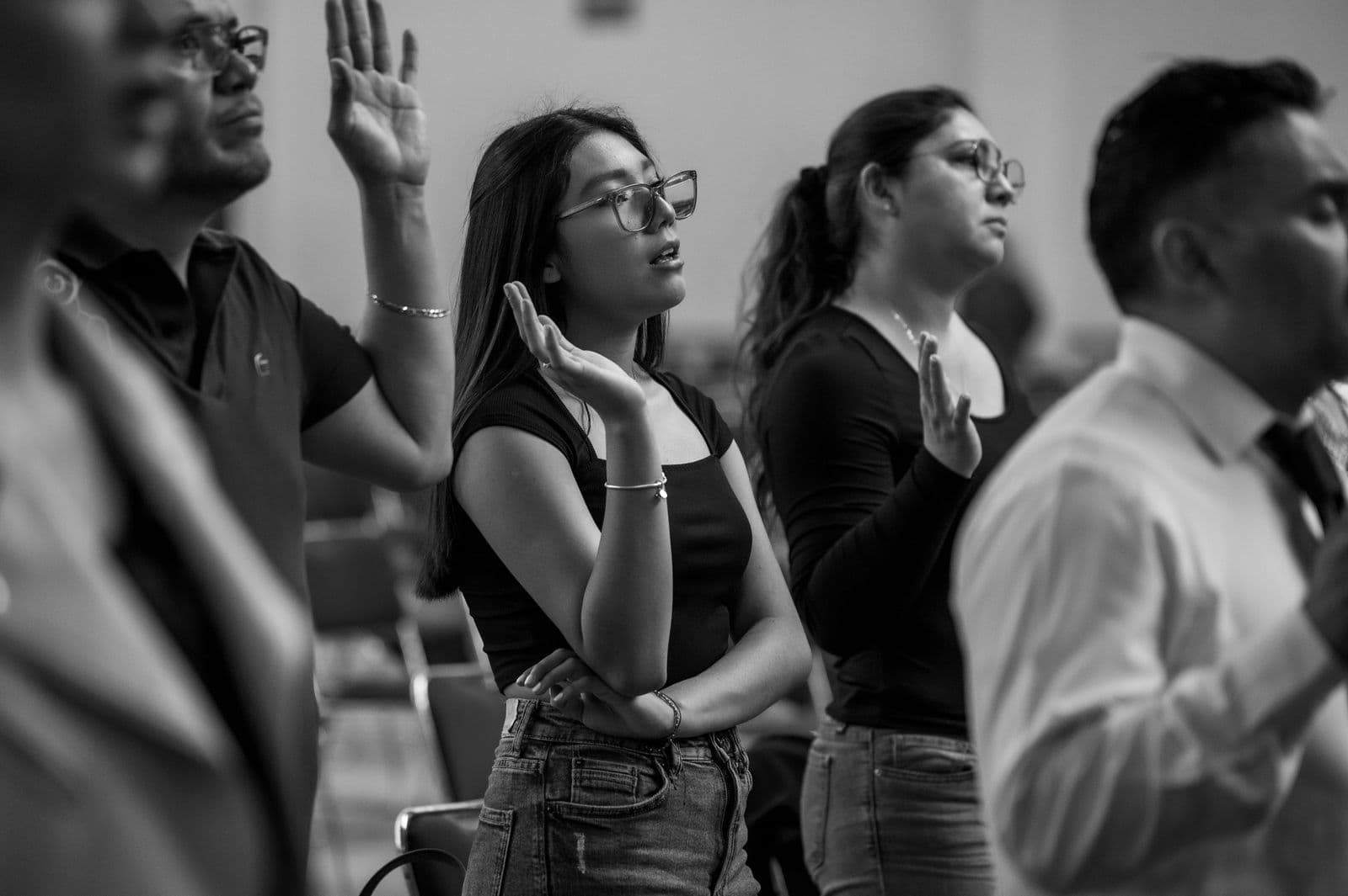 A worshipper with hands raised during a Sunday service